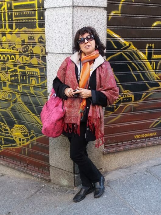 Elizabeth Adum, the Spanish Foreign Language Department Chair, standing in front of a concrete pillar