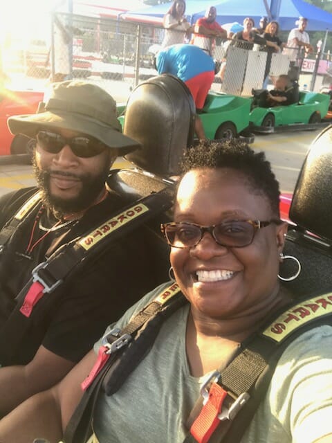 Selena Smith, sixth grade teacher at McLean School, smiles for camera while go-karting