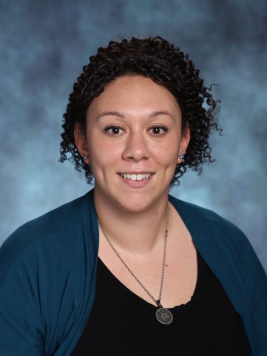 Lauren Merikas, Counselor in the Upper School at McLean School, smiles in front of camera