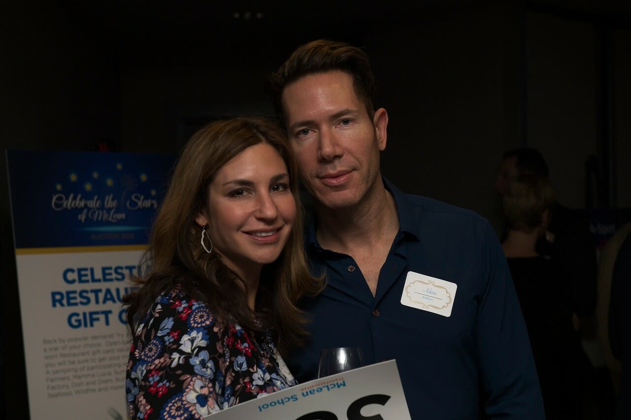 a man and a woman smiling for the camera